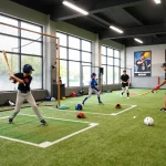 Young athletes practicing at hitclub's advanced baseball training facility with batting cages and coaching sessions.